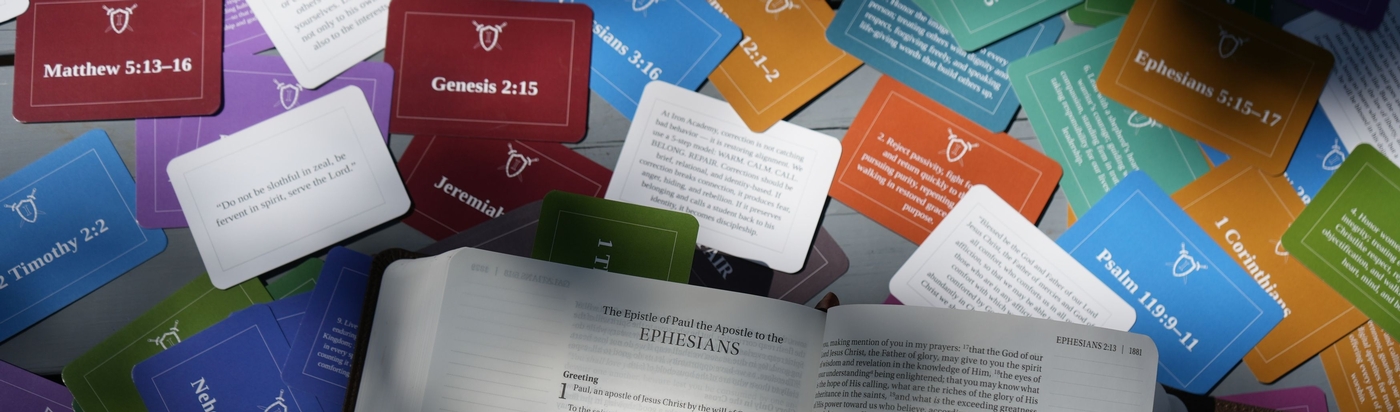 An open Bible with colorful flash cards for memorization of ForgePoint
