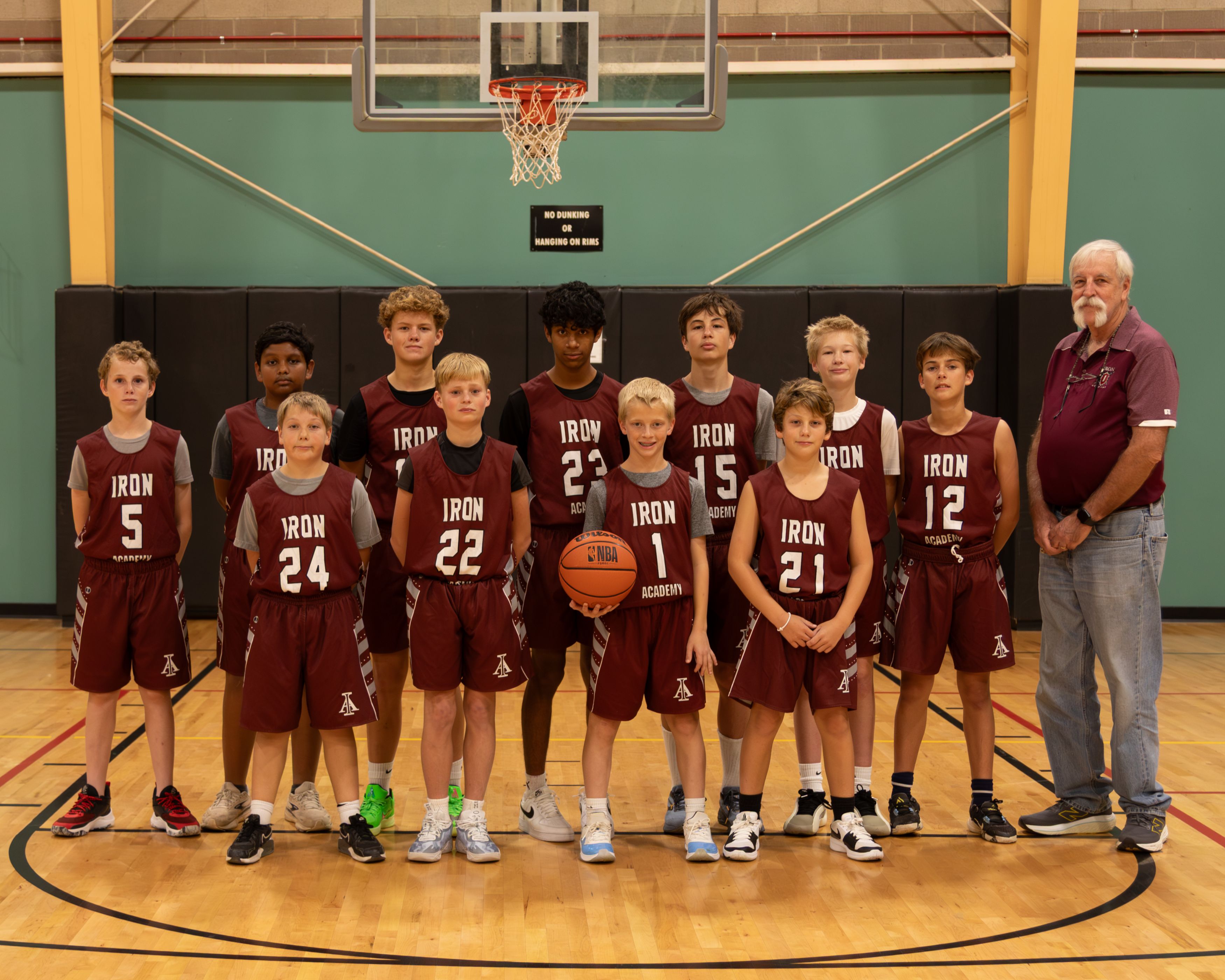Image shows the middle school basketball team and their coach.